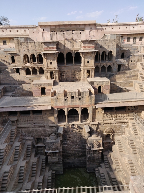      Ancient stepwell or stone structure with intricate design.
  