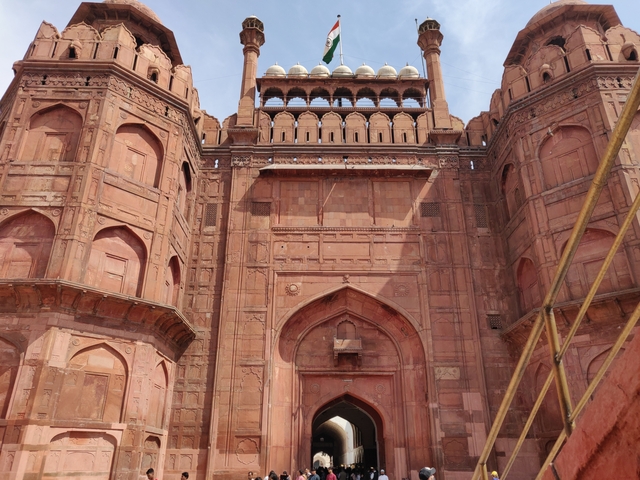 Close-up of a historical gate with red sandstone architecture.