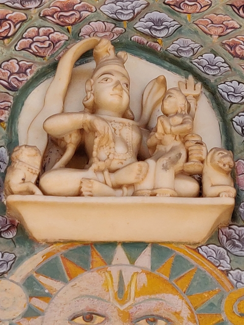       Intricate stone carving depicting a mythological scene.
  