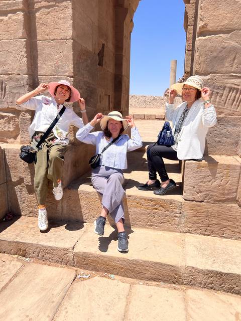 Four friends posing inside ancient ruins.