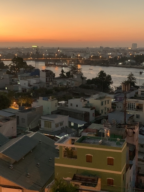       A cityscape at dusk or dawn showing a river and buildings.
  