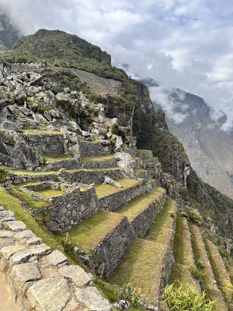       Andean terraces under a cloudy sky.
  