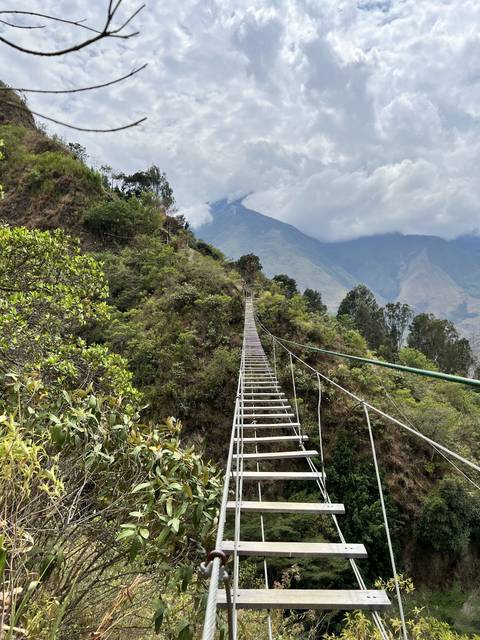       Hanging bridge over a mountainous landscape.
  