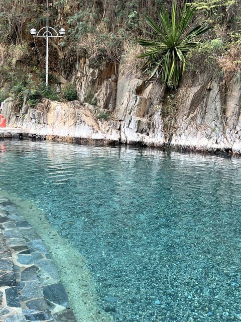       Close-up of a rocky pool with clear water.
  