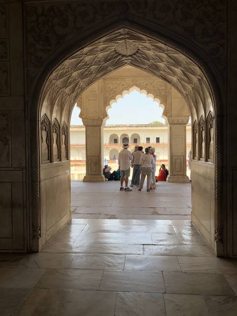Group inside a historical building with arches