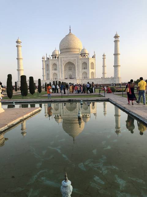 Taj Mahal with reflecting pool and visitors
