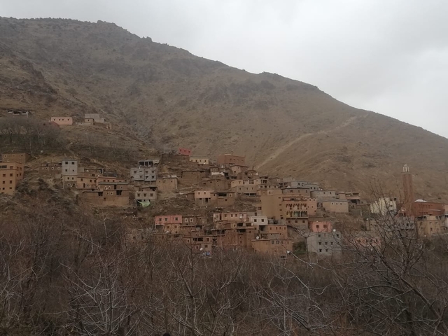 A hillside village with clustered buildings.