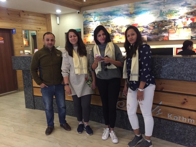       Group of people at a hotel lobby with city map in the background.
  