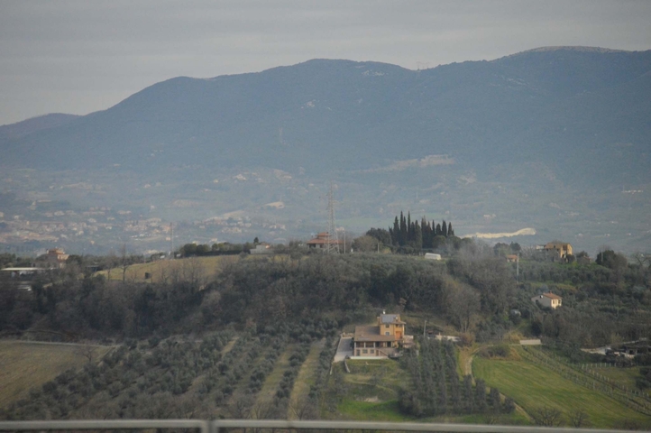 Countryside view with hills and buildings