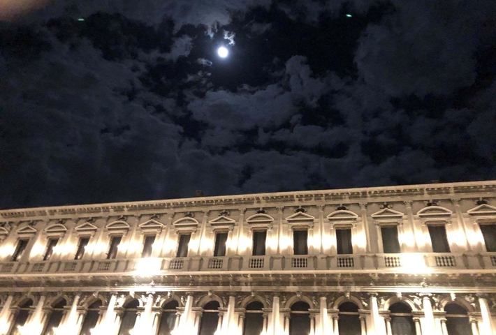 Nighttime view of an illuminated historic building