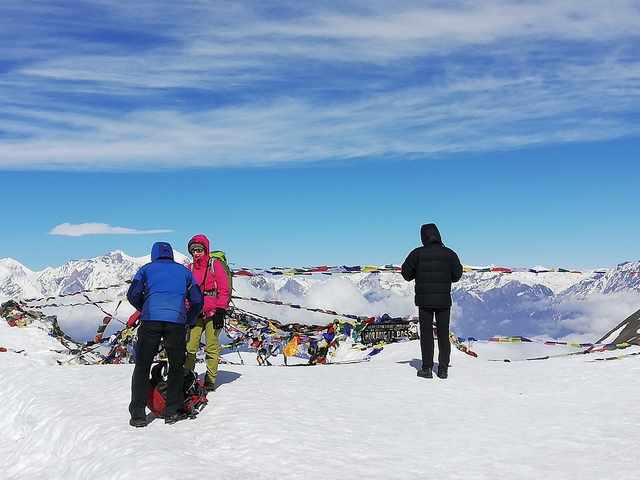       Hikers with backpacks in a snowy mountain range
  