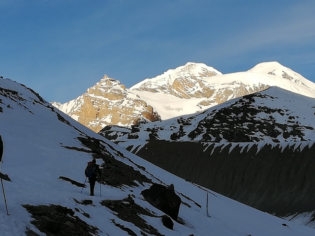       Person hiking in snowy mountains
  