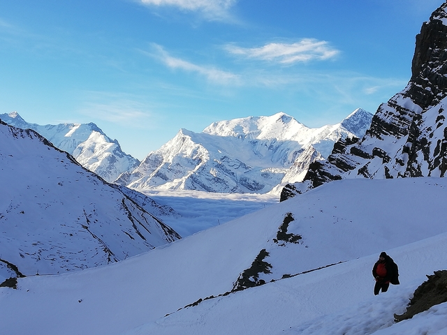       Hiker in a snowy mountain valley
  
