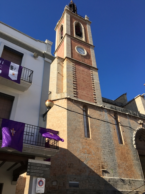       Historical building with banners and a blue sky.
  