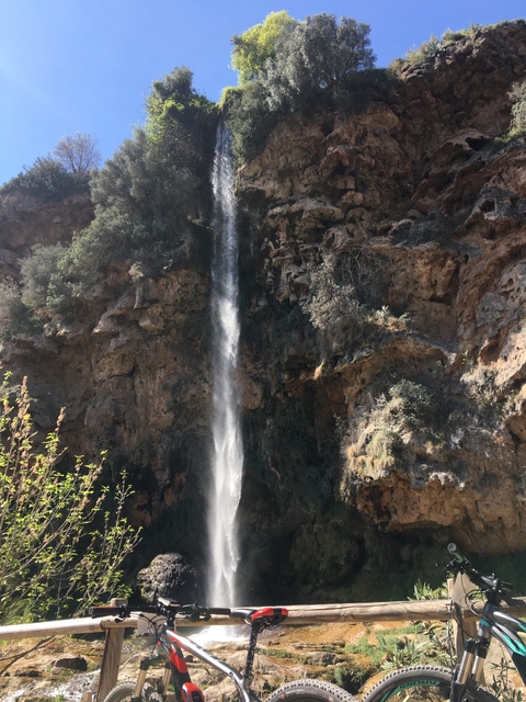 Tall waterfall cascading down a rocky cliff face.
