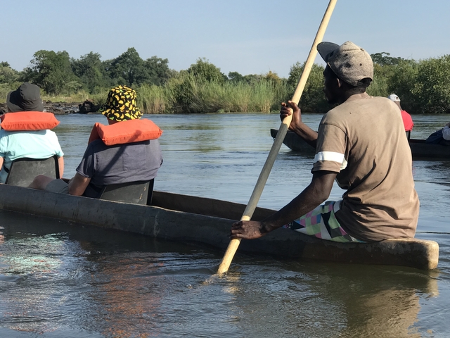 People in a canoe on a river safari.