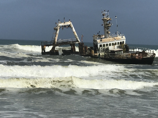      An abandoned ship in rough waters.
  