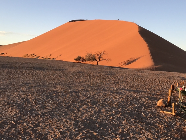       Large sand dune with sparse vegetation.
  