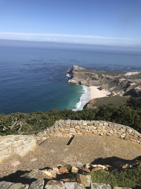       Coastal cliffs with waves crashing at the base.
  