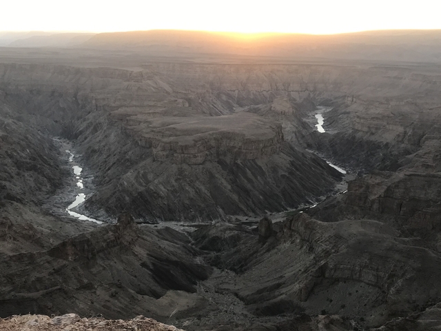       Vast canyon landscape at sunset.
  