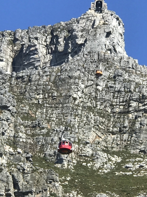       Cable car on rocky mountainside.
  