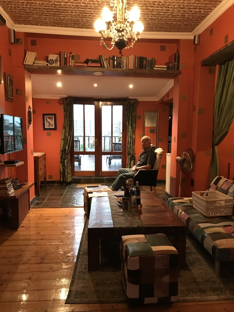       Person sitting indoors near a window.
  