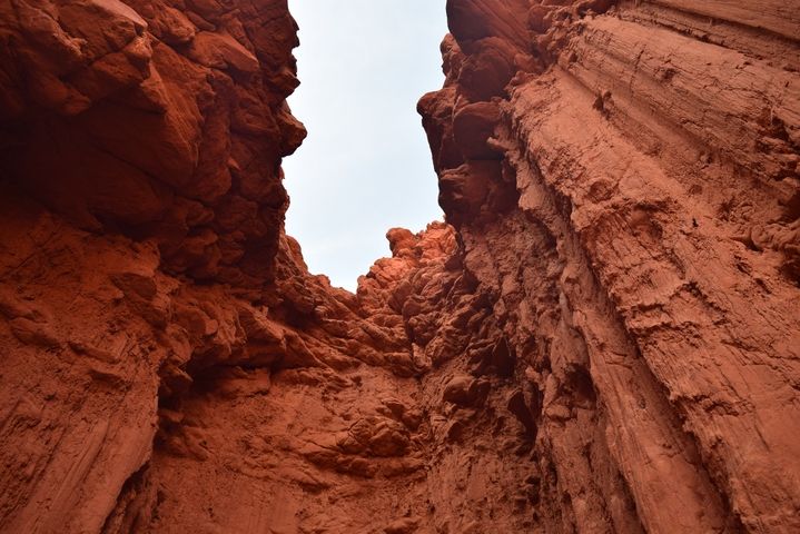       Red rock formations with a clear sky above.
  