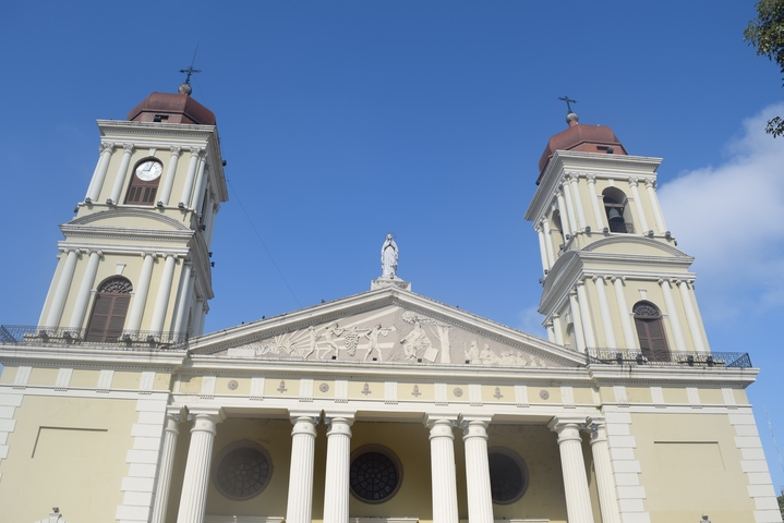       Cathedral facade with large columns under a bright sky.
  