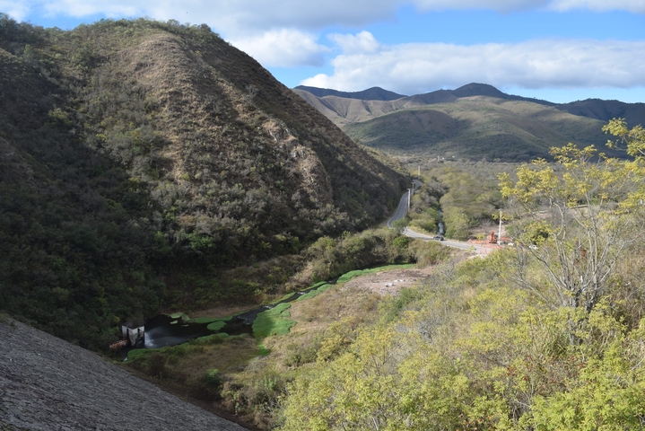Curvy road through lush, green hills.