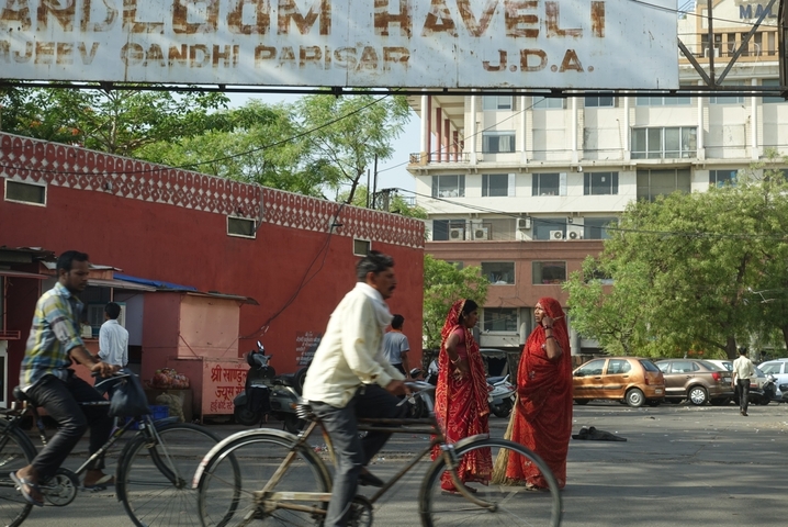 People walking and cycling in an urban area.