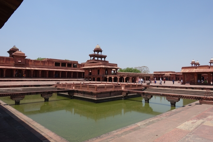Fatehpur Sikri's courtyard with red sandstone buildings.