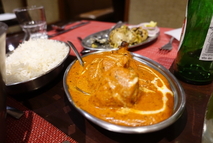 Traditional Indian butter chicken dish with rice.