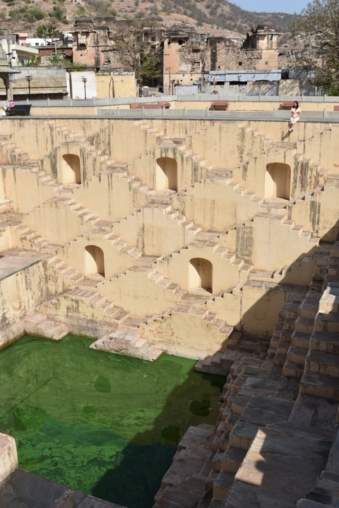       Intricate stepwell with geometric staircase design.
  
