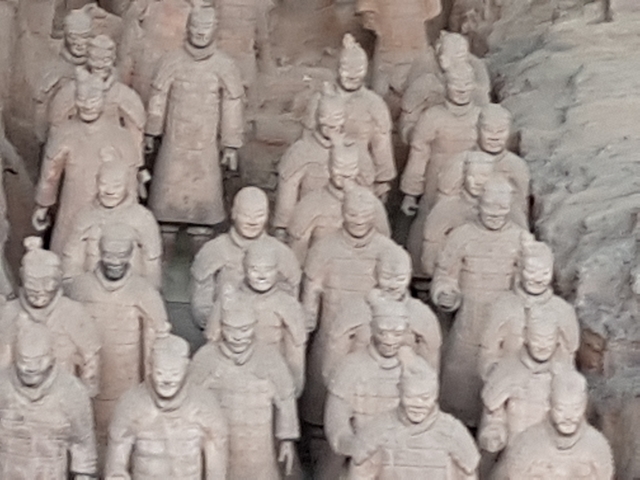 Display of terracotta soldiers in an archaeological site.