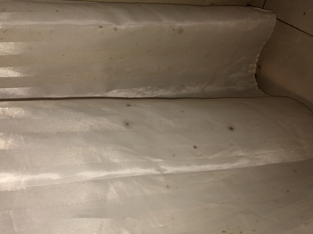       Stained and wrinkled fabric surface.
  