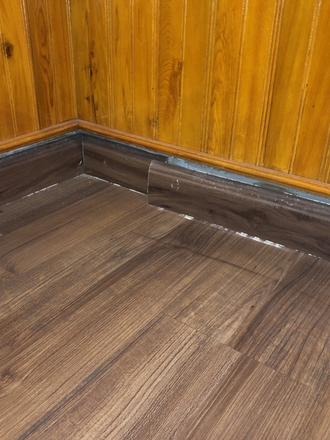 Wooden flooring with skirting board.