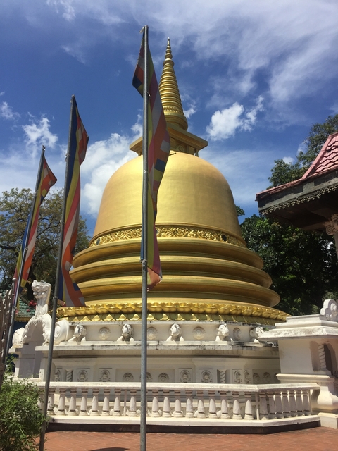 Golden stupa with decorative flags.