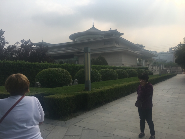       Two people in front of a large building resembling a museum.
  