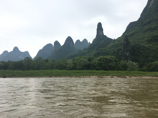       Karst mountain range beyond a river.
  