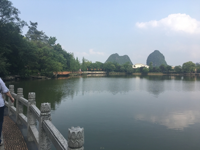       Scenic lake with karst mountains in the background.
  
