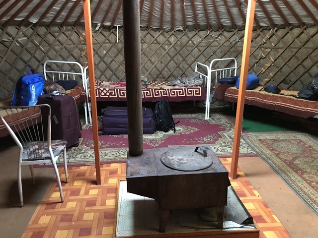 Interior of a yurt with beds and luggage