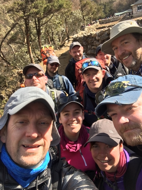       Group selfie of trekkers with outdoor gear
  