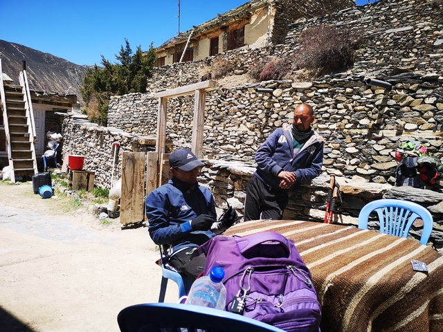 Two men talking in a rocky village
