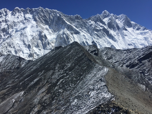 Contrasting rocky and snowy mountain terrain.