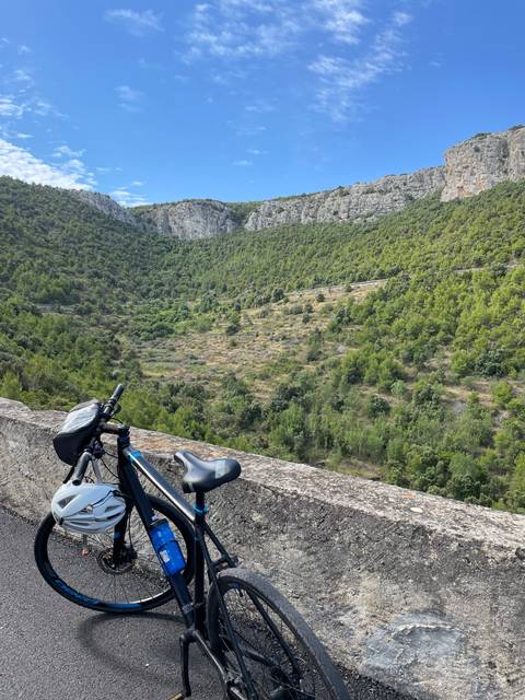       Bicycles parked overlooking a scenic landscape.
  