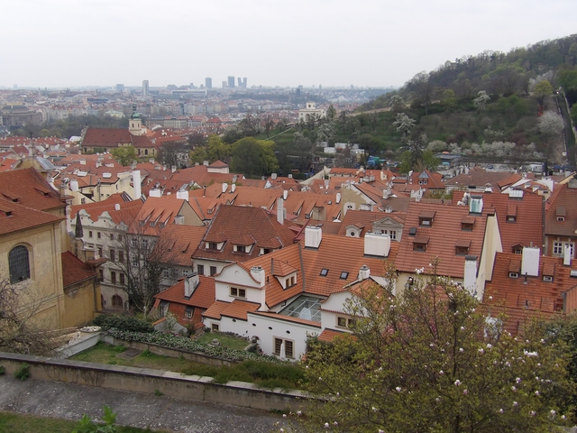       Aerial view of a city with many red-tiled roofs.
  