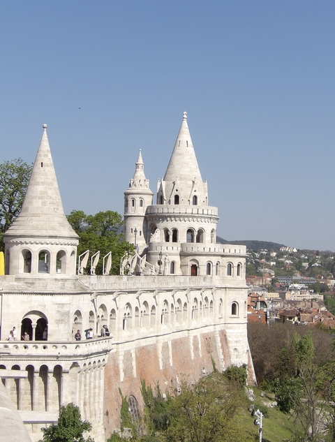       Castle structure with turrets and a panoramic city view.
  