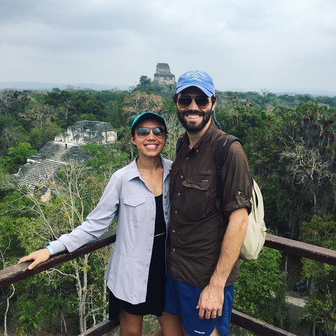       Couple on a lookout with an ancient temple visible in the background.
  