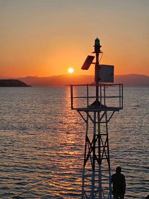       Sunset with a structure in the sea
  