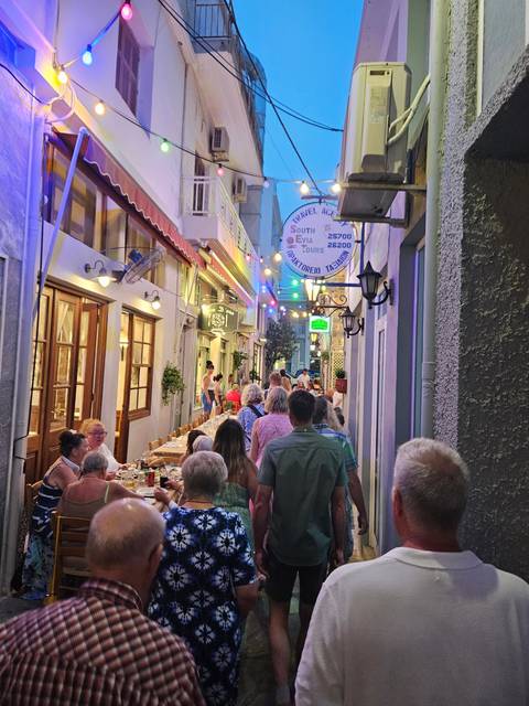       Crowded street with restaurants
  